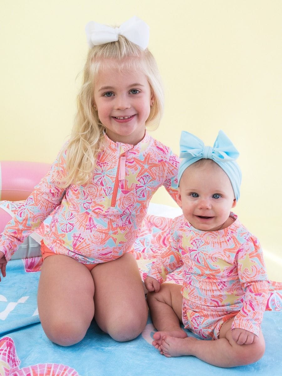 RuffleButts + RuggedButts Baby Long Sleeve One Piece Rash Guard Swimsuit, With Signature Rear Ruffles