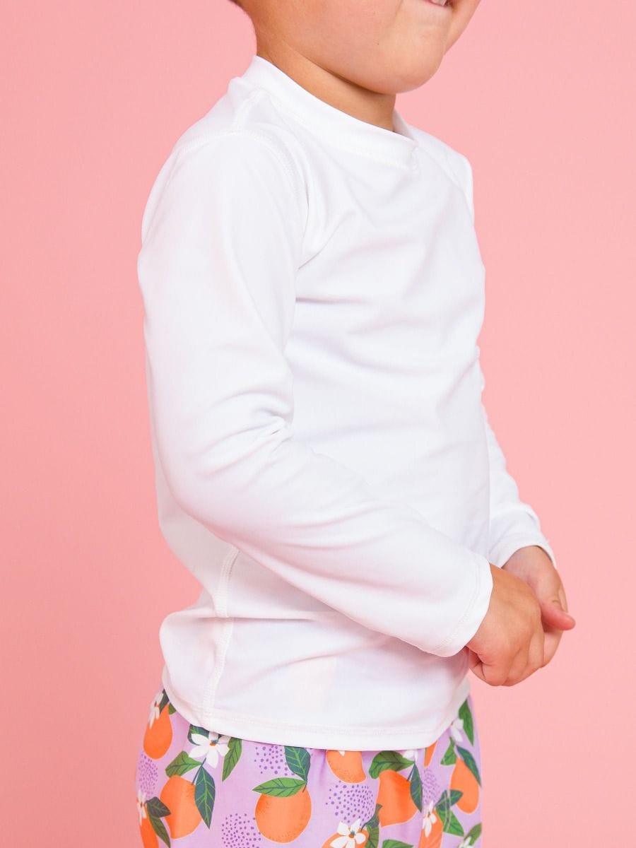 RuffleButts + RuggedButts Baby Long Sleeve Rash Guard, White