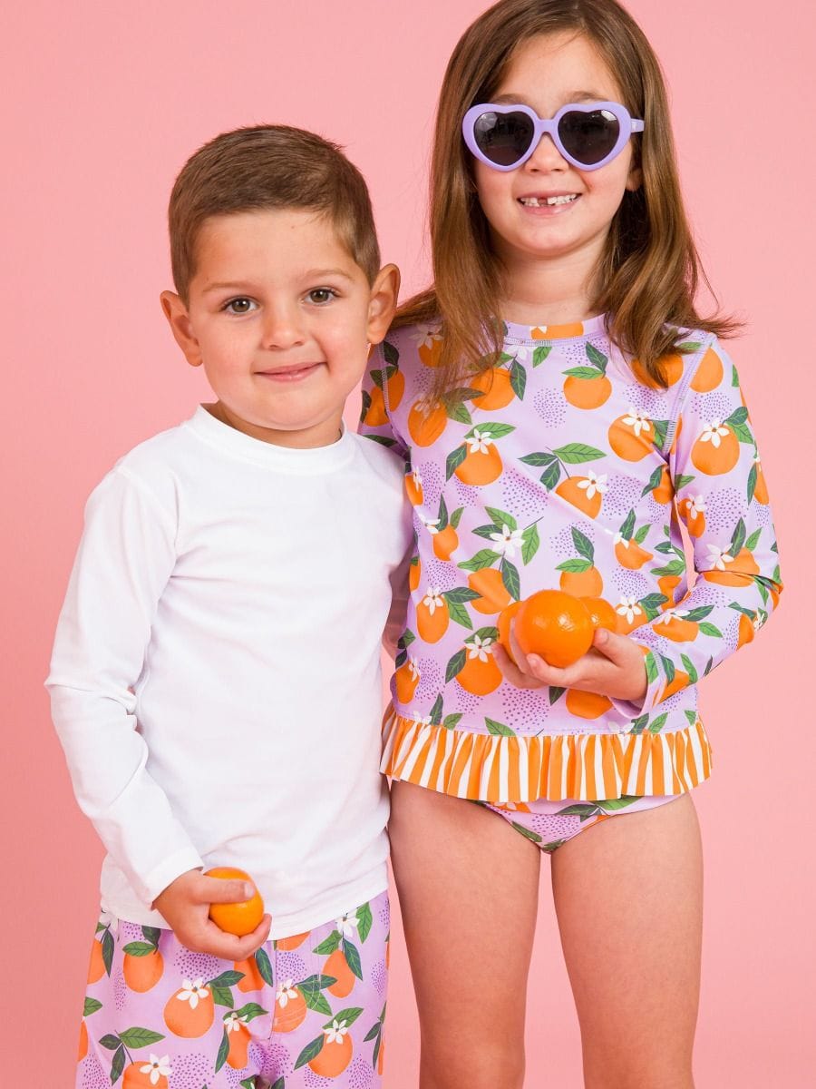 RuffleButts + RuggedButts Baby Long Sleeve Rash Guard, White
